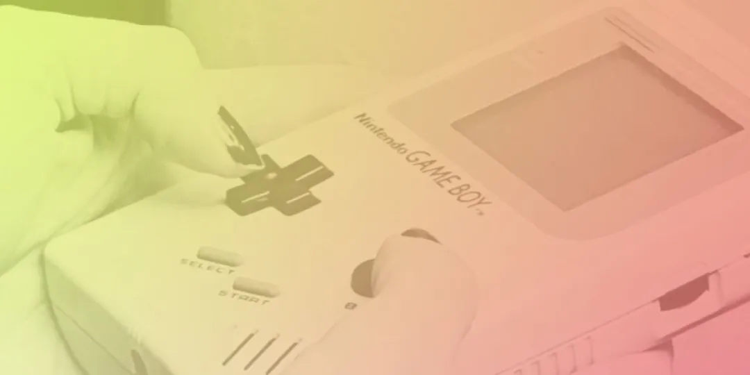 Close up of a person's hands playing a Game Boy