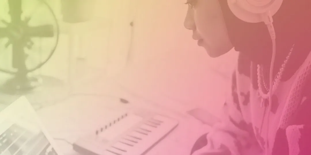 Image of a person using a laptop and keyboard