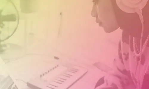 Image of a person using a laptop and keyboard