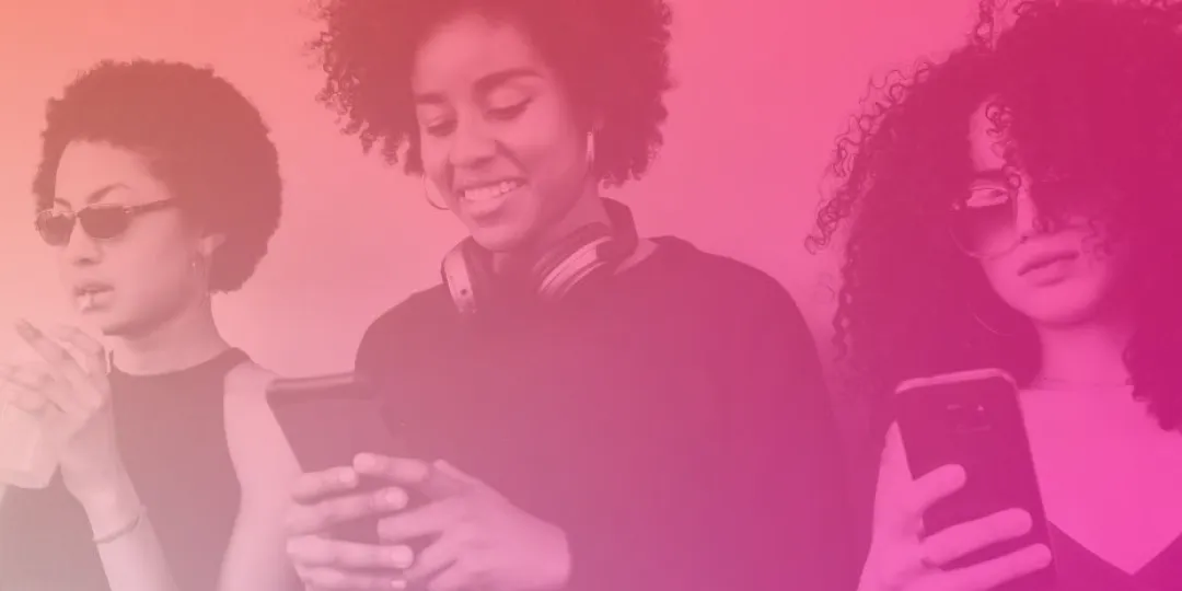 Image of three people looking down at their phones